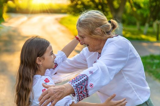 Ukrainian grandmother and granddaughter in vyshyvanka. selective focus. Kid.