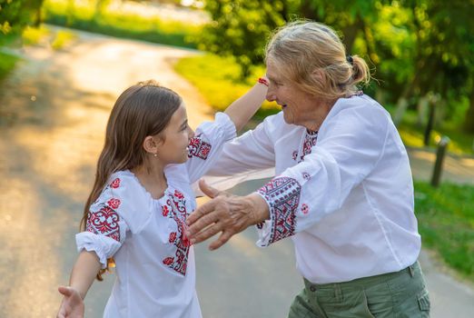 Ukrainian grandmother and granddaughter in vyshyvanka. selective focus. Kid.