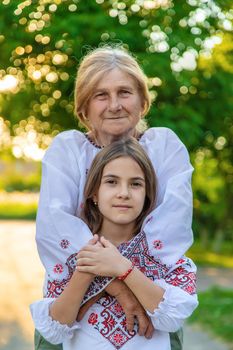 Ukrainian grandmother and granddaughter in vyshyvanka. selective focus. Kid.