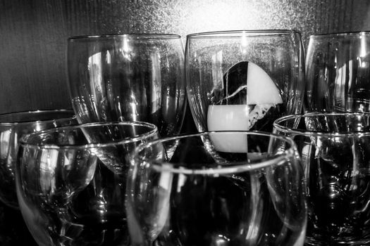 marble stone black and white egg in a glass glass on a black background. The concept of contrast, sinfulness and light. minimalism