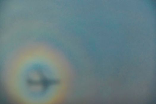 blurry shadow of the airplane on the cloud with the rainbow circle. traveling concept. High quality photo
