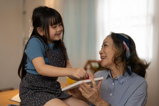 Asian portrait, grandchild granddaughter grandma grandmother and granddaughter happily join in activities to enhance skills for grandchildren.