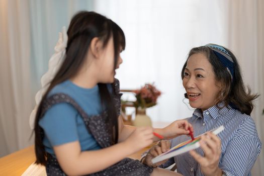 Asian portrait, grandchild granddaughter grandma grandmother and granddaughter happily join in activities to enhance skills for grandchildren.