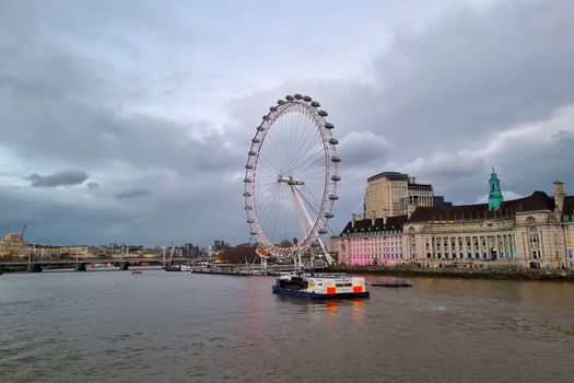 London, United Kingdom, February 7, 2022: Scenic view of the River Thames in London. The London Eye is a Ferris wheel in London, located in the Lambeth district on the south bank of the Thames. The largest in Europe and one of the largest in the world.