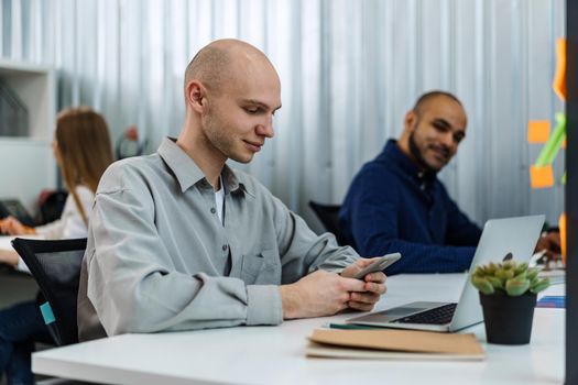 Group of young business people working in modern office together