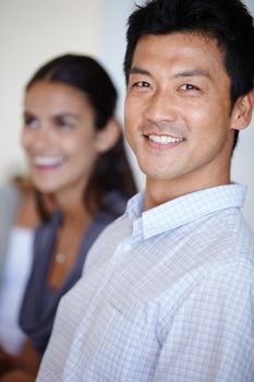 Shot of two business people seated in an office environment.