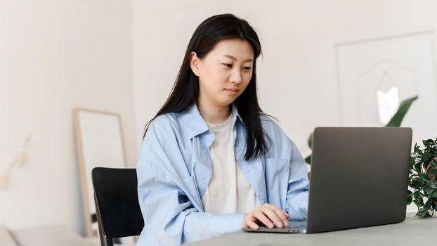 Business asian woman working on laptop at home. Small business owner or freelancer is trained in a home environment. Web banner.