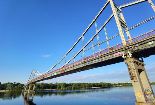 Kyiv, Ukraine - May 24, 2022: Landscape of the pedestrian bridge in Kiev. Summer time.