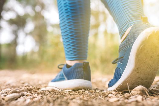 detail of a woman's trainers. woman athlete playing sport outdoors. concept of wellbeing and healthy living. outdoors, natural sunlight.