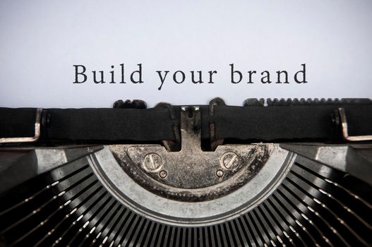 Build your brand text typed on an old vintage typewriter. Branding concept