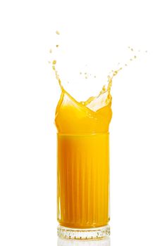 orange juice splash isolated on white. glass of splashing orange juice. fresh orange fruit juice splashing in glass. stock photo