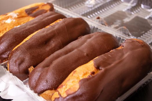 Chocolate custard cakes in plastik box close up