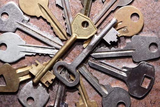 Set of various old keys closeup on brown background