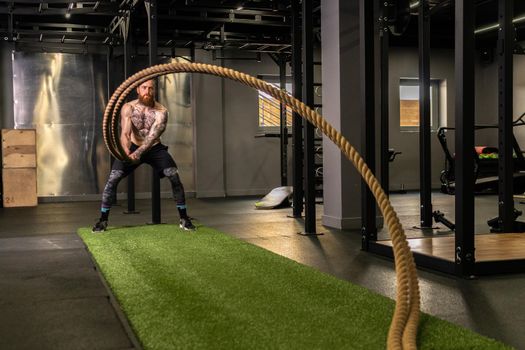 Rope man grass warehouse green fitness training gym exercising exercise, for athlete one from male from healthy moving, sport muscle. Standing ground holding, lifestyles