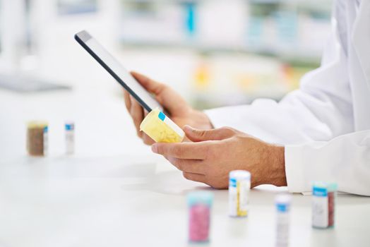 A pharmacist working on a digital tablet.