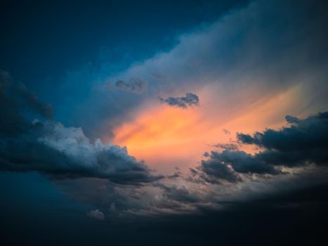 Orange light among the dark stormy cloudscape