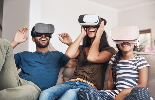 Shot of a young family using virtual reality headsets together at home.