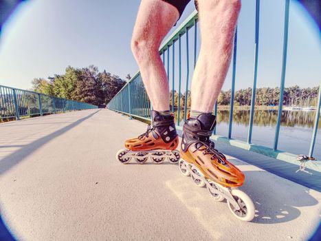 Doksy range, Czech Republic, 9th of October 2018. Roller skater ride in park. Boy legs in in-line hard shell boots blades.