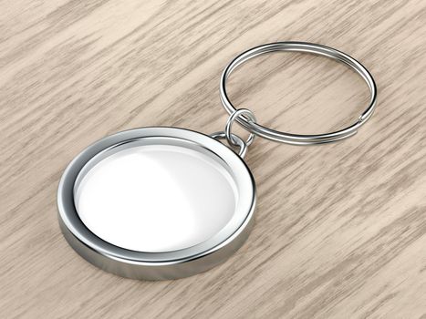 Blank round keychain on wood background