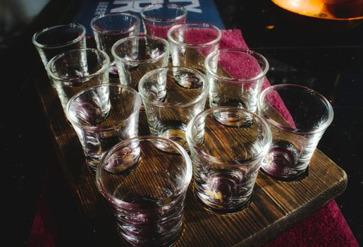 Shot glasses set in a wooden tray in a traditional English pub