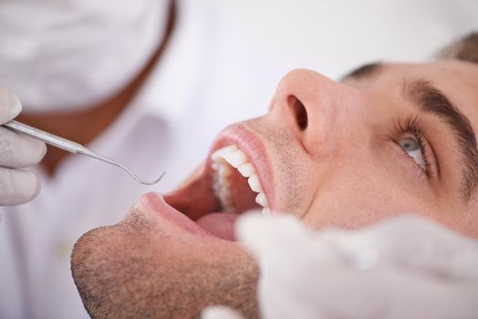 Cropped shot of a young man at the dentist.