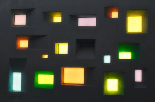Modern design wall with abstract windows of different shapes and colored lights