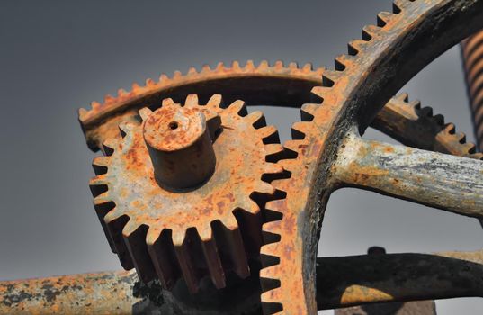 Old rusty metal industrial gears or cogs used in retro machinery
