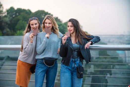 three girls eating chocolate with nuts