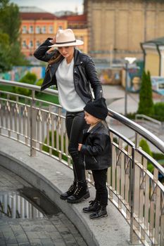 mom and daughter have fun walking around the city