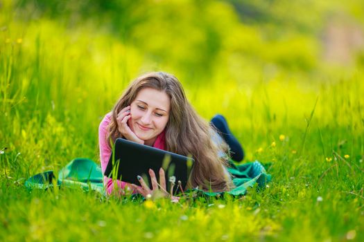 portrait of a girl with a tablet in nature