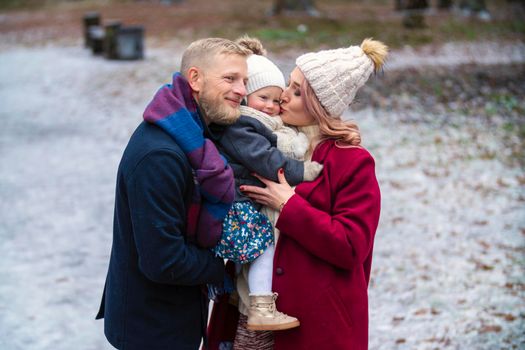 family with a child in the park in winter