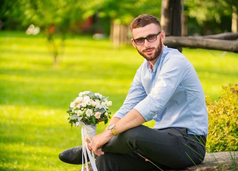 guy with a wedding bouquet in his hands