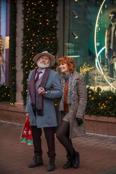 elderly couple on the background of a shop window