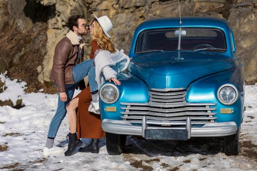 stylish couple hugging near retro car