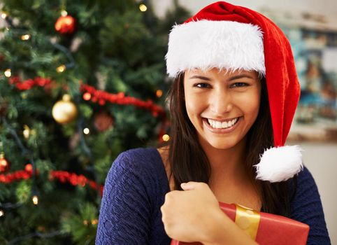Portrait of a young woman hold a Christmas gift.
