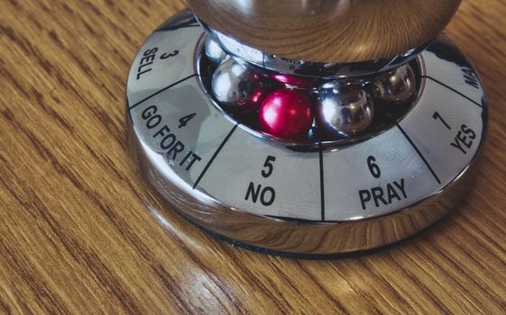 Metal decision maker with 'No' selected from the wheel of options
