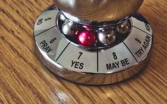 Metal decision maker with 'Yes' selected from the wheel of options