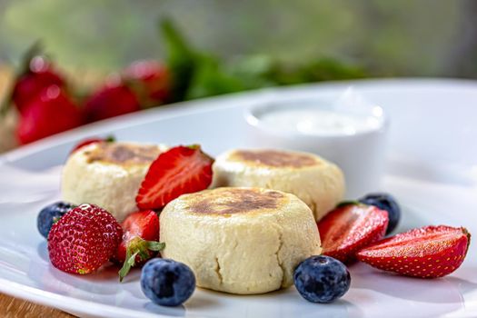 Homemade cheesecake with fresh strawberries and blueberries dessert - healthy organic summer dessert pie cheesecake. Vanilla Cheese Cake.