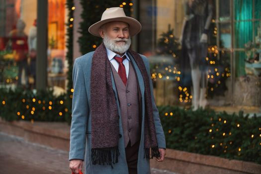 portrait of a bearded man aged on the street in the city