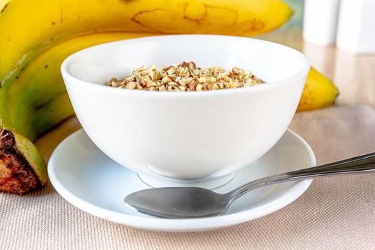 Dessert bowl of tasty chia seed pudding with banana on white background.