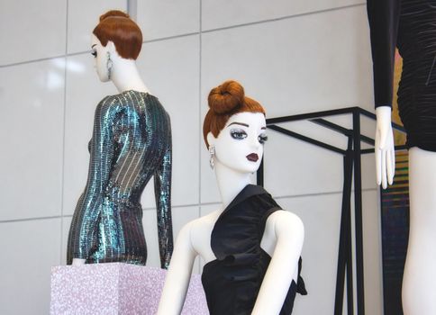 White fashion mannequins displaying elegant clothes