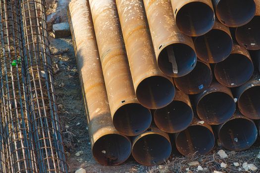 Industrial construction material - pipes stacked in a pyramid