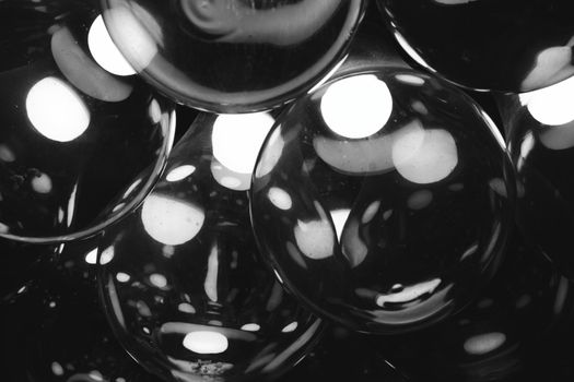 Abstract black and white glass light bulbs with a warm glow