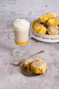 pumpkin cinnabons and latte for dessert, holiday table with pastries, home sweet home, autumn menu. High quality photo