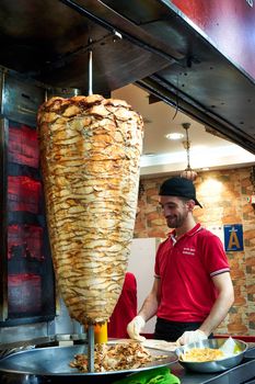 Shawarma street food counter. Meat frying on pole, while cooking. Kuala Lumpur, Malaysia - 03.08.2020