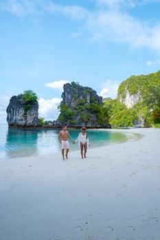 Koh Hong Island Krabi Thailand, a couple of men and women on the beach of Koh Hong, a tropical white beach with Asian women and European men in Krabi Thailand