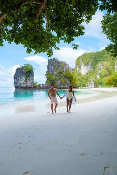 Koh Hong Island Krabi Thailand, a couple of men and women on the beach of Koh Hong, a tropical white beach with Asian women and European men in Krabi Thailand