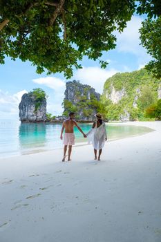 Koh Hong Island Krabi Thailand, a couple of men and women on the beach of Koh Hong, a tropical white beach with Asian women and European men in Krabi Thailand