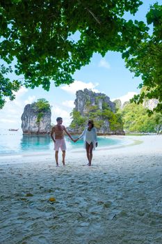 Koh Hong Island Krabi Thailand, a couple of men and women on the beach of Koh Hong, a tropical white beach with Asian women and European men in Krabi Thailand