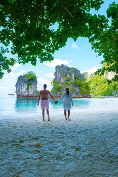 Koh Hong Island Krabi Thailand, a couple of men and women on the beach of Koh Hong, a tropical white beach with Asian women and European men in Krabi Thailand